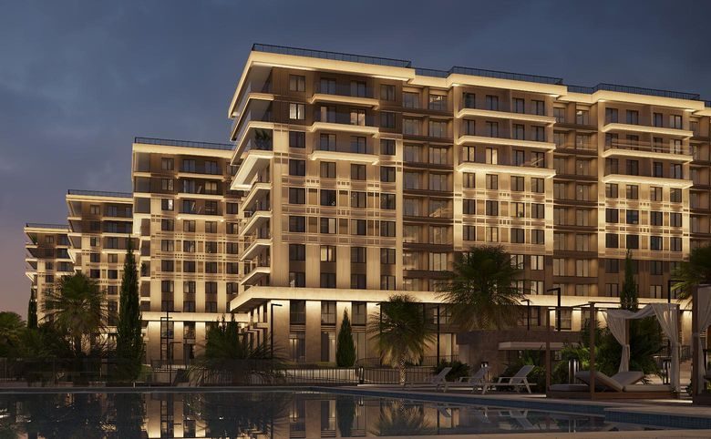 Гостиничный комплекс GREENMONT — Фасад с вечерней подсветкой и озеленённой набережной у бассе